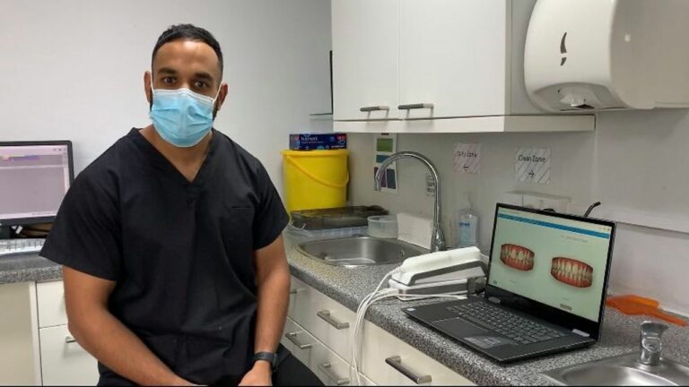 Reporter Ben Jolley talks his ongoing teeth transformation thanks to March Dental Surgery, Dr Kishan Patel (pictured) and Invisalign. – Credit: ARCHANT